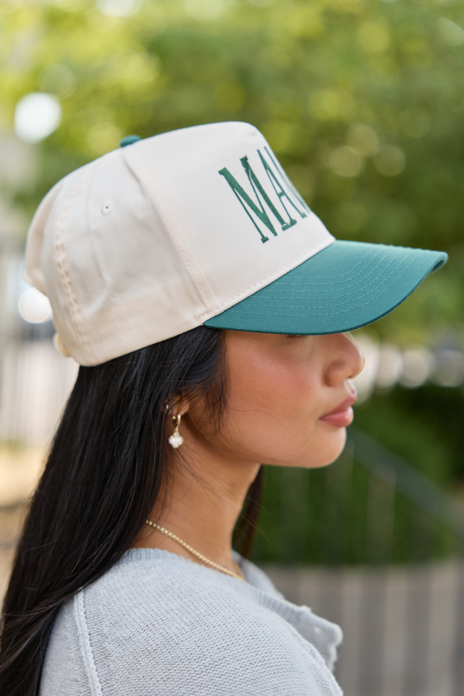 Natural MAMA embroidered hat with a green brim, worn with a gray cardigan.