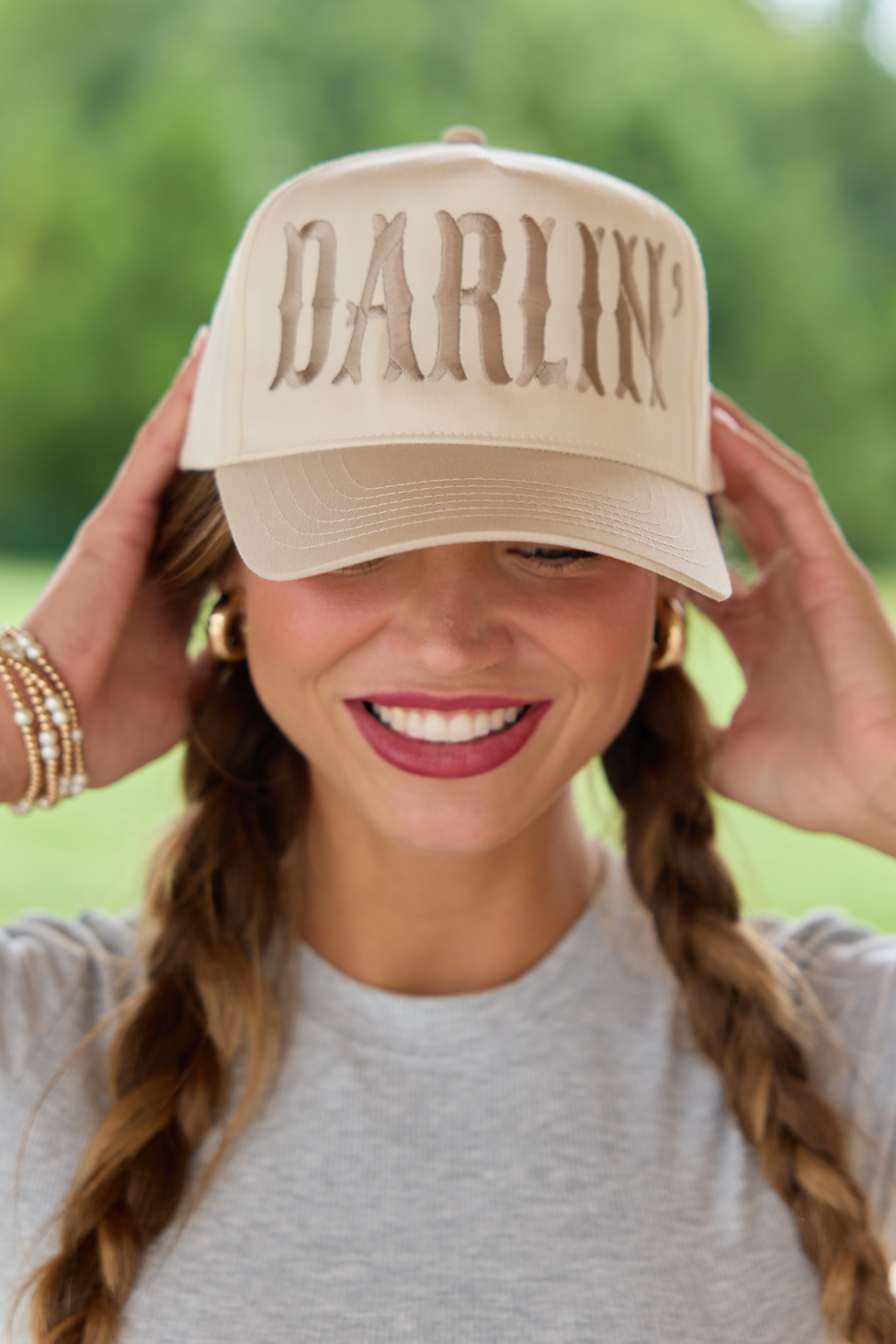 Front view of a natural hat with large khaki DARLIN' embroidery and a curved brim.