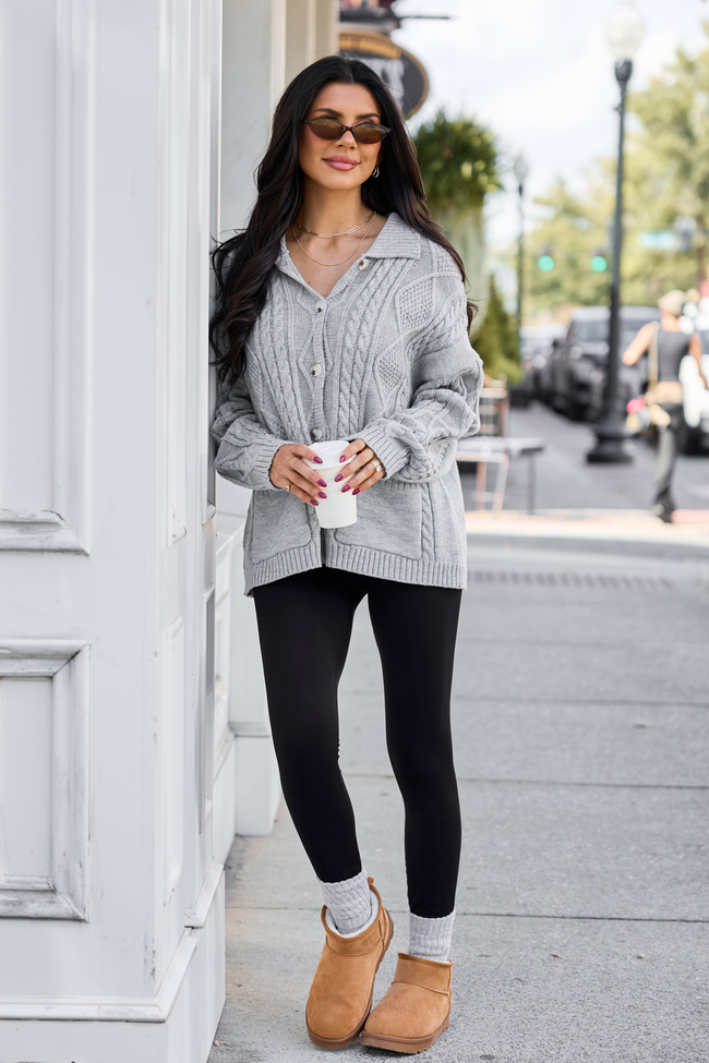 Front view worn with brown shorts outdoors — grey collared cable-knit button cardigan.