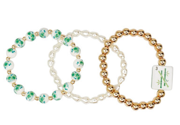 Stacked three-piece bracelet set with green floral beads, faux pearls, and gold-tone beads with a 3 Bamboo tile charm.