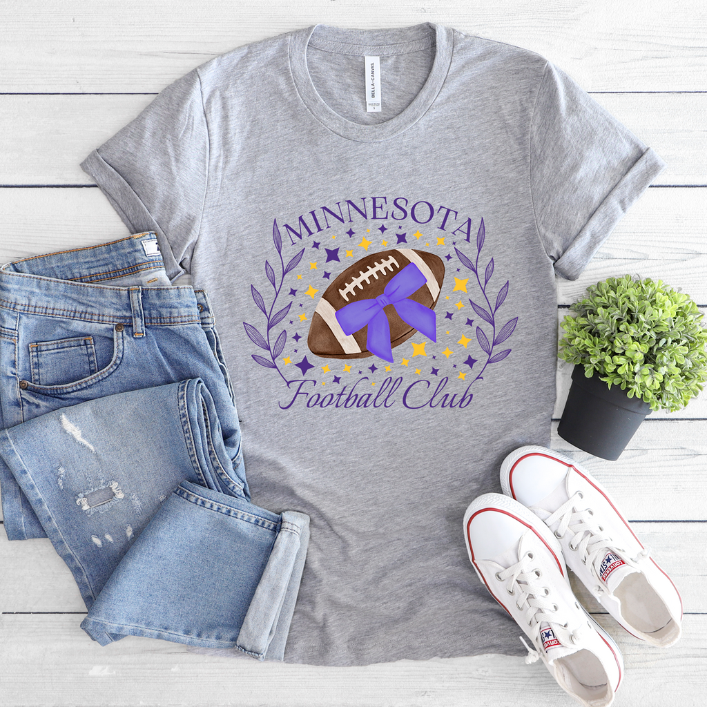 Heather gray Minnesota Football Club crewneck with a purple and yellow football design framed by leafy branches.