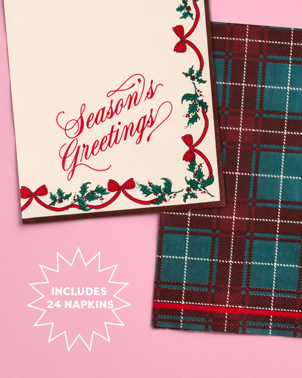 Cream Season's Greetings napkin layered over a red and green plaid napkin.