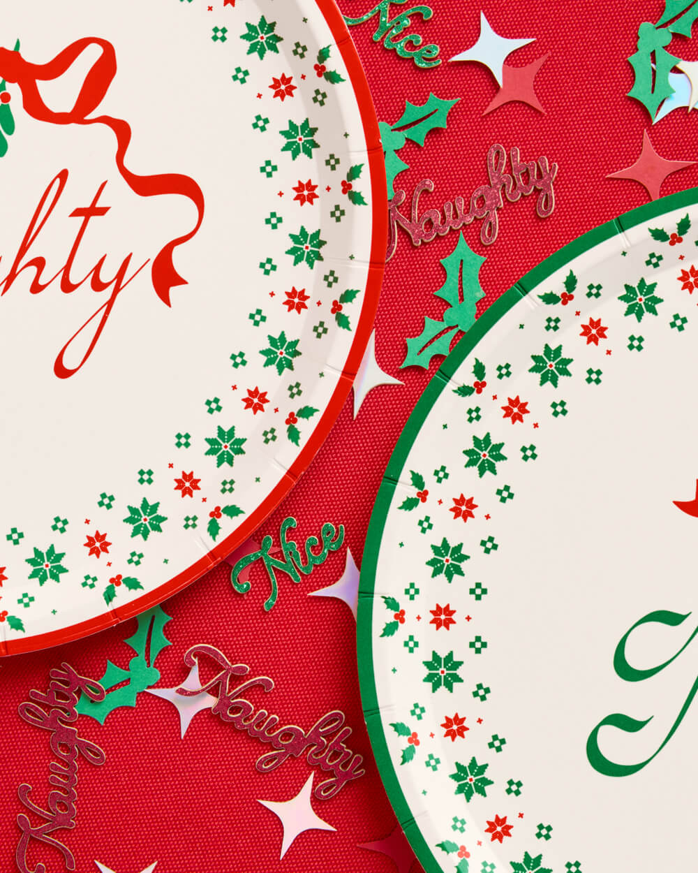 Naughty and Nice dessert plates with red bows and green snowflake borders.