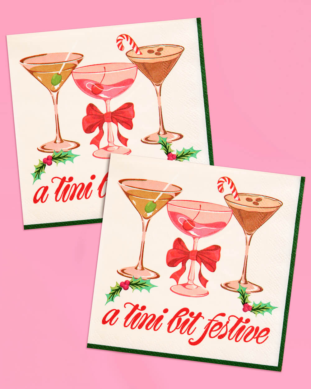 Cream cocktail napkins printed with martinis, a red bow and 'a tini bit festive' lettering.